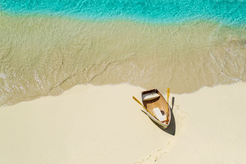 A small boat in the Caribbean on a beach